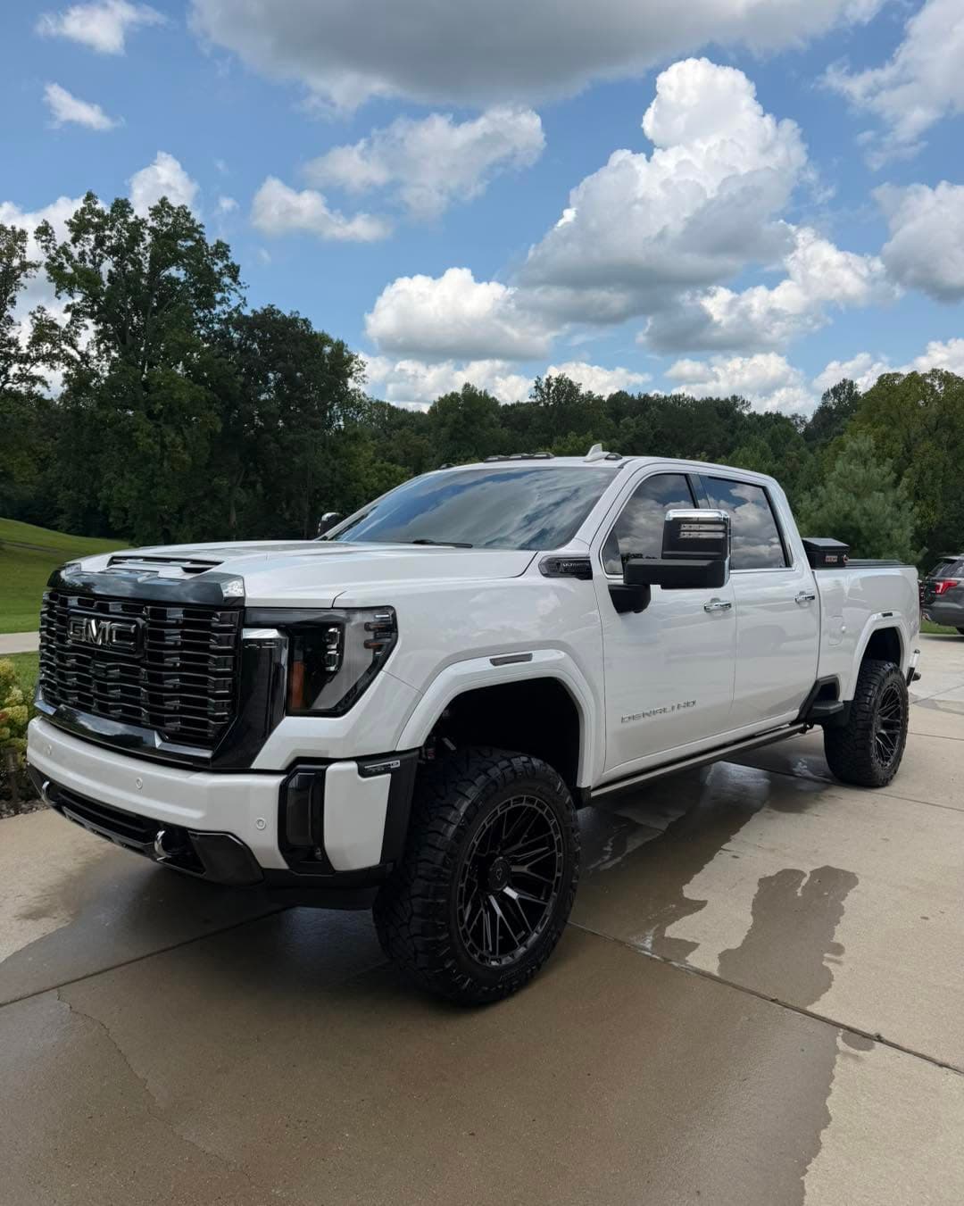 White lifted GMC Denali after a detail